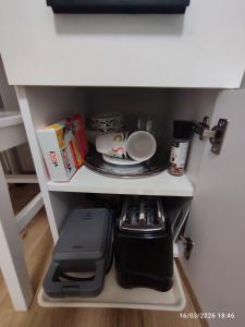 a shelf in a kitchen with a coffee maker at Transilvania Studio in Sibiu +15 photos
