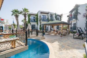 a hotel with a swimming pool in front of a building at Orion hotel in Bodrum City