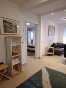 a living room with a couch and a table at Appartement am Goldsteinpark in Bad Nauheim