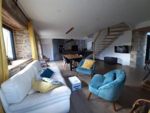 a living room with a white couch and blue chairs at Gîte coup de cœur in Pluvigner +22 photos