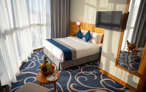 a hotel room with a bed and a mirror at Reya Creek Hotel in Dubai