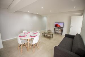 a living room with a table and a couch at Guest H4U Povoa Vacation City center in Póvoa de Varzim