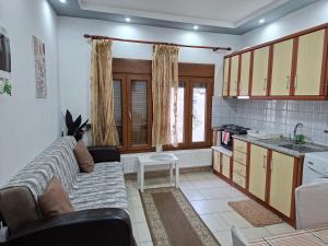 a living room with a couch and a kitchen at Paradise Bridge in Xanthi