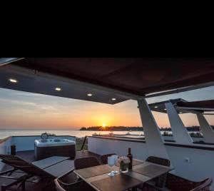 a table on a boat with a view of the ocean at Sealodge Novigrad Number 18 in Novigrad Istria