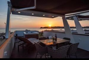 a patio with a table and chairs on a boat at Sealodge Novigrad Number 18 in Novigrad Istria