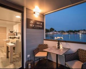 a table and chairs in a room with a view of the water at Sealodge Novigrad Number 18 in Novigrad Istria