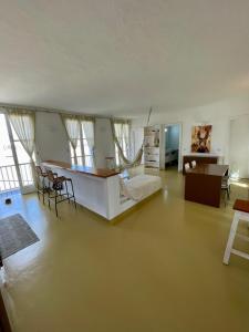 a large living room with a couch and a table at Surf House Casa Vehla in Sal Rei