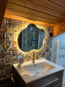 a bathroom with a sink and a mirror on the wall at CASA RURAL EL TORREON in Fontiveros +24 photos