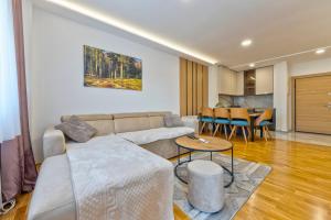 a living room with a couch and a table at Vip Bogic 108 in Zlatibor