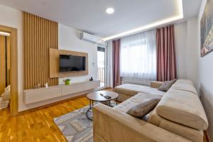 a living room with a couch and a tv at Vip Bogic 108 in Zlatibor
