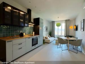 a kitchen with a table and a living room at Saverio & Daria Aprtements by Mamo Florence in Florence