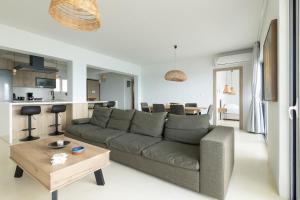 a living room with a couch and a table at Euphoria Mare in Néa Palátia