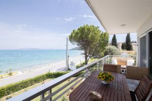 a balcony with a table and a view of the ocean at Euphoria Mare in Néa Palátia