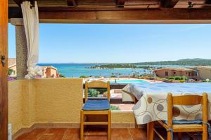 a balcony with a table and chairs and a pool at Villaggio Marineledda in Santa Marinella
