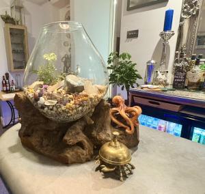 a glass bowl with a fish tank on a table at Penryn House Hotel in Polperro