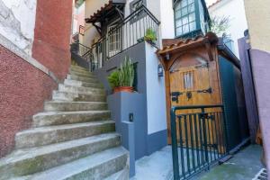 a set of stairs leading up to a wooden door at Casa Fernandes by Mth in Ribeira Brava