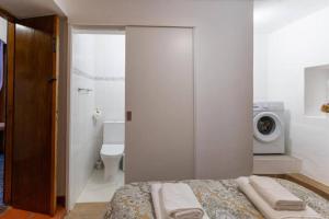 a bedroom with a bed and a bathroom with a toilet at Casa Fernandes by Mth in Ribeira Brava +15 photos