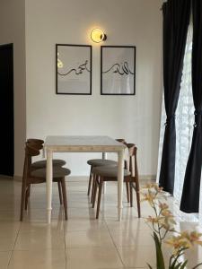 a dining room with a table and chairs at Eryna Homestay in Nibung Tebal