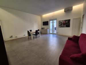 a living room with a couch and a table and chairs at Casa Bon in Marigliano