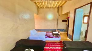 a room with a couch and a bed in it at Kasbah Restaurant Citoyenne in Agoudal