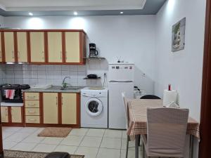 a kitchen with a washing machine and a washer at Paradise Bridge in Xanthi +8 photos