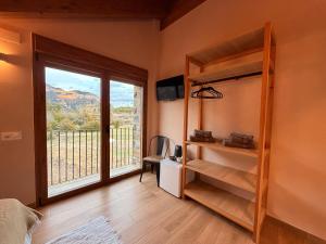 a bedroom with a large window with a view at As Fuebas de Patricio in Vío