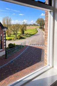 a view from a window of a street at Rustig verblijf bij de Rijn - Lobith in Lobith