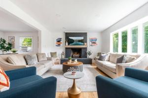 a living room with two couches and a fireplace at Indoor Pool Poconos Retreat with Arcade in Lake Ariel