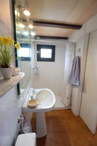 a white bathroom with a sink and a shower at TURISMe RURAL EMPORDA in Torroella de Montgrí +34 photos