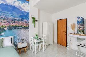 a bedroom with a bed and a table with a view at Lecco's heart! Centro Lecco - A due passi dal lago - Moderno e luminoso in Lecco