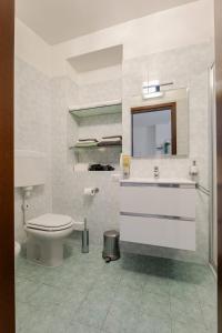 a bathroom with a toilet and a sink and a mirror at Lecco's heart! Centro Lecco - A due passi dal lago - Moderno e luminoso in Lecco +11 photos