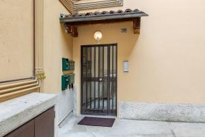 a building with a door with bars on it at Lecco's heart! Centro Lecco - A due passi dal lago - Moderno e luminoso in Lecco
