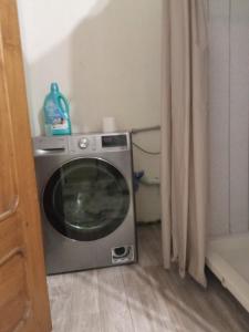 a washing machine sitting in a room next to a window at room with a mountain view in Zugdidi