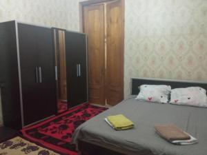 a bedroom with a bed and a mirror at room with a mountain view in Zugdidi