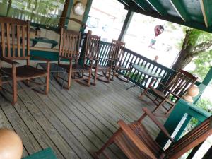 a group of chairs and a table on a deck at Historic Matewan House Lodging in Matewan