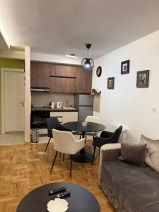 a living room with a couch and a table at PRESTIGE apartman Krusevac in Kruševac