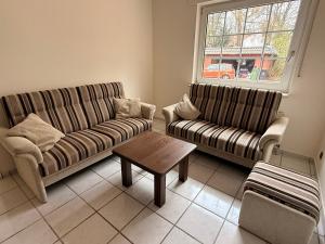 a living room with two couches and a coffee table at Haus an der Hase in Bramsche