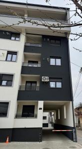 a black and white apartment building at PRESTIGE apartman Krusevac in Kruševac