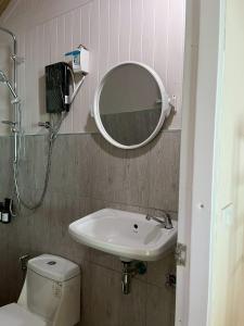 a bathroom with a sink and a mirror and a toilet at Wildnest House in Ko Yao Noi +13 photos