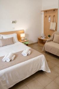 a bedroom with a large bed with towels on it at Residence Hotel Claudia in Alba Adriatica +43 photos