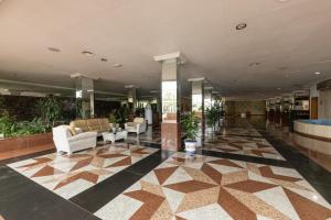 a lobby with couches and plants in a building at BLUESEA Costa Jardin & Spa in Puerto de la Cruz