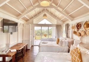a large room with two beds and a table at Finca San Cayetano in San Juan Alotenango