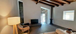 a living room with a couch and a tv at Casa Branca AL in Monchique
