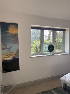 a room with a window with a painting on the wall at Knowle Grange Guest House in Frant +17 photos