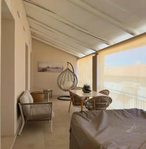 a room with a balcony with a table and chairs at Stella di Mare with Jacuzzi, Costa Smeralda in Arzachena
