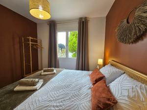 a bedroom with a bed with two pillows on it at La fleur des eaux de Beauval in Noyers-sur-Cher