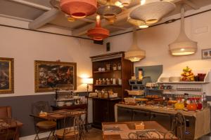 a room with a kitchen with a counter and tables at Aurora Boutique Hotel & Private SPA - Etruria Collection in Spoleto