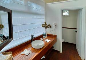 a bathroom with a wooden counter with a sink at Finca San Cayetano in San Juan Alotenango +37 photos