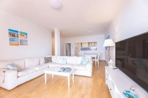 a living room with a white couch and a table at Capo d'Arco - Quadrilocale Le Mimose in Capo D'Arco