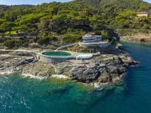 an aerial view of a house on a rocky island in the water at Capo d'Arco - Quadrilocale Le Mimose in Capo D'Arco